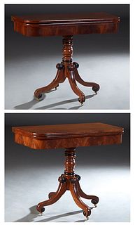 Pair of Regency Style Carved Mahogany Games Tables, 19th c., the rounded edge top opening to a silver gilt tooled leather playing surface, on a turned