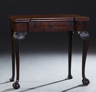 English Carved Mahogany Chippendale Style Games Table, early 20th c., the breakfront edge top over a frieze drawer, on cabriole legs with ball and cla