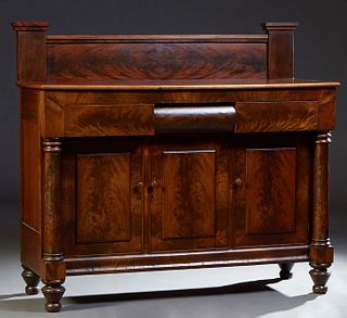 American Classical Carved Mahogany Sideboard, late 19th c., the stepped splash back over a rounded edge rectangular top over a center convex frieze dr