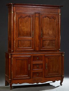 French Provincial Louis XV Style Carved Oak Buffet a Deux Corps, 19th c., the stepped cookie corner crown over two double panel doors with iron fiche 