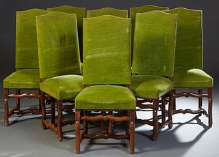 Set of Eight French Louis XIII Style Carved Beech Dining Chairs, early 20th c., the arched canted upholstered back over a trapezoidal cushion seat, on