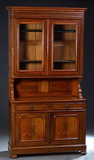 French Louis Philippe Carved Walnut Buffet a Deux Corps, 19th c., the stepped ogee crown over double arched glazed doors with original glass, on scrol