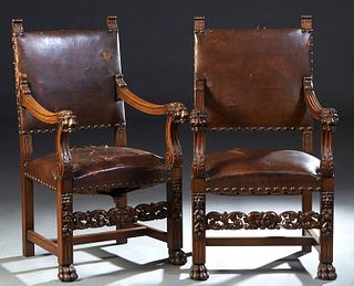 Pair of French Provincial Carved Oak Fauteuils, c. 1880, rectangular back to curved arms with lions head terminals, to an upholstered seat, on lion, f