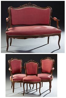 French Louis XV Style Carved Walnut Four Piece Parlor Suite, 19th c., consisting of a pair of fauteuils, a side chair and a settee, the arched C-scrol