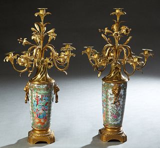 Pair of Chinese Famille Rose Porcelain and Gilt Bronze Six Light Candelabra, early 20th c., the six floral candle cups over the tapered vase with lion