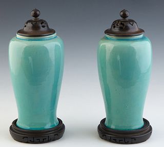 Pair of Chinese Teal Glazed Baluster Urns, late 19th c., the underside with an impressed chop mark, now on carved mahogany bases, with carved mahogany