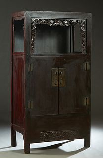 Chinese Carved Elm Worship or Display Cabinet, 19th c., the rectangular top over open storage behind a pierced border, above double doors with brass h