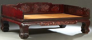 Chinese Carved Elm Opium Bed, late 19th c., with a 3/4 gallery carved back over a rattan top, on large cabriole legs, H.- 37 1/2 in., W.- 96 in., D.- 