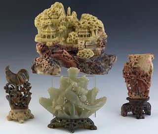 Group of Four Chinese Soapstone Carvings, 20th c., consisting of a bird and flower example on a carved soapstone base, a large landscape carved exampl