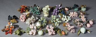 Large Group of Carved Oriental Stone and Jade items, 20th c., consisting of 16 grape bunches and 11 pieces of fruit. (27 Pcs.) Provenance: The Collect