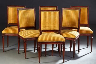 Set of Six French Louis XVI Style Carved Walnut Dining Chairs, 20th c., reeded rectangular upholstered back to a trapezoid cushioned seat, on turned t