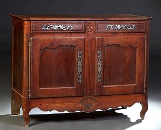 French Provincial Louis XV Style Carved Walnut Sideboard, early 19th c., the ogee edge rounded corner top over two frieze drawers with iron escutcheon