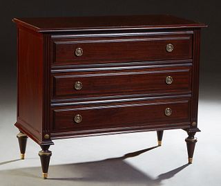 French Louis XVI Style Carved Mahogany Commode, 20th c., the rounded edge top over three drawers, flanked by reeded pilasters, on turned tapered legs,
