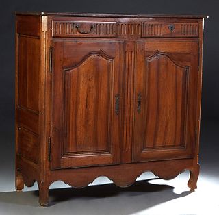 French Provincial Louis XV Style Carved Walnut Sideboard, early 19th c., the stepped canted corner top over two reeded frieze drawers with iron heart 