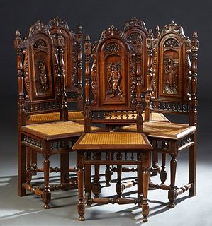 Set of Five Spanish Renaissance Style Carved Oak Dining Chairs, the highbacks with figural carving, over a spindled gallery, to a trapezoidal caned se