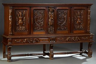 Spanish Renaissance Style Carved Oak Sideboard, 20th c., the stepped ogee crown over four cupboard doors, two with a carved winged woman with a crown,