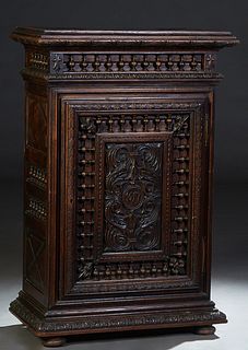 French Provincial Henri II Style Carved Oak Confiturier, 19th c., the stepped top with incise carved sides, above spindled front and side galleries, o