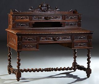 French Henri II Style Carved Oak Desk, c. 1880, the back with a three-quarter gallery carved splash over five fitted drawers and open storage, on a ga