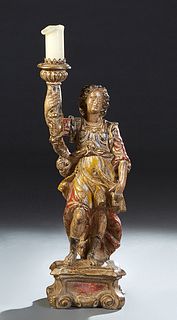 Large Continental Polychromed Terracotta Figural Candlestand, early 20th c., of a Saint upholding a torch, on an integral scrolled base, now wired as 