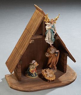 Conrad Moroder, Five Piece Carved Wood Nativity Set, 20th c., consisting of a manger, an angel, Baby Jesus, Joseph, and Mary, Manger- H.- 19 1/2 in., 