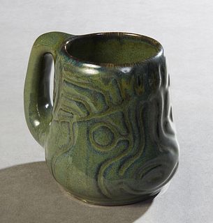 Shearwater Art Pottery Fish Mug, 21st c., molded by Walter Anderson, decorated in an antique green glaze, H.- 4 1/2 in., W.- 4 in., D.- 5 1/2 in. Prov