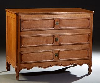 French Provincial Louis XV Style Carved Oak Commode, 19th c., the stepped canted corner top over three deep drawers flanked by reeded pilasters, on sc