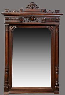 French Provincial Henri II Style Carved Oak Overmantel Mirror, c. 1900, the stepped crown over an egg and leaf carved frieze above a setback arched wi