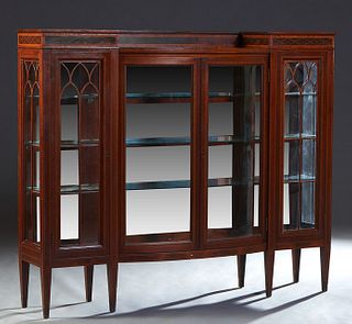 English Edwardian Inlaid Mahogany Bowfront Display Cabinet, c. 1910, the stepped top over double glazed curved glass doors flanked by narrow Gothic ar