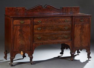 English Chippendale Style Carved Mahogany Sideboard, early 20th c., the scrolled back splash over a breakfront top over a central bank of three drawer
