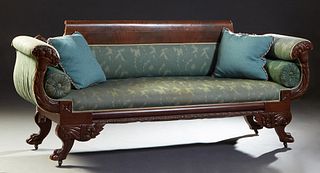 American Classical Carved Mahogany Settee, 19th c., the wide crest rail over an upholstered back flanked by upholstered cornucopia carved arms, flanki