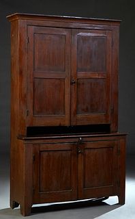 American Carved Walnut Kitchen Cupboard, 19th c., Pennsylvania, the ogee crown over double cupboard doors, on a base with like double cupboard doors r
