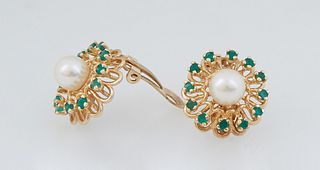Pair of 14K Yellow Gold Clip Earrings with a central 7mm white cultured pearl, within a pierced outer border of twelve round 5 point emeralds, Total E