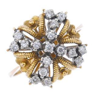 A diamond dress ring. Of openwork design, the brilliant-cut diamond, interspaced by bead and grooved