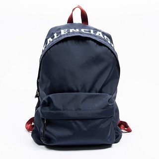 Balenciaga Wheel Logo Backpack, in navy nylon canvas with red straps and silvered hardware, opening to a matching navy lined interior with a large ope