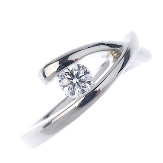An 18ct gold diamond single-stone dress ring. Of crossover design, the brilliant-cut diamond, to the