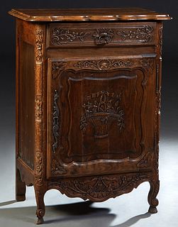French Provincial Louis XV Style Carved Beech Confiturier, early 20th c., the stepped rounded corner serpentine top over a frieze drawer above a flora