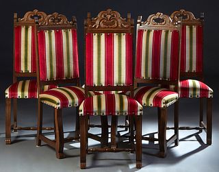 Set of Six Spanish Renaissance Style Carved Oak Dining Chairs, 20th c., the arched highback with hand holes, over a cushioned back and trapezoidal sea