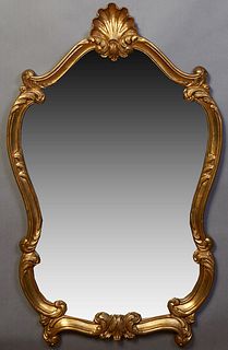 French Louis XV Style Carved Giltwood Overmantel Mirror, 20th c., of cartouche form, with a shell form crest, H.- 42 in., W.- 25 in., D.- 1 3/4 in.