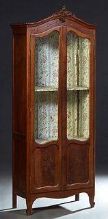 Diminutive Louis XV Style Carved Mahogany Bookcase, c. 1900, the stepped arched crown with a floral and C-scroll crest over arched double doors with g