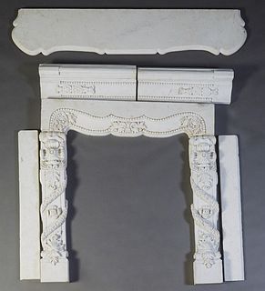 Carved White Marble Fireplace Mantel, late 19th c., the ogee edge serpentine top above a thick serpentine skirt, flanked by floral and garland carved 