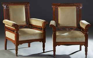 Pair of American Faux Bois Carved Oak Armchairs, late 19th c., the rounded crest rail over a cushioned back, flanked by upholstered arms on pierced ar