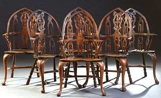 Unusual Set of Six English Gothic Style Carved Yew Windsor Armchairs, 18th c., the curved Gothic arched spindled back, with curved arms, over a wide b