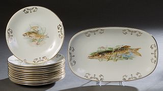 French Thirteen Piece Ceramic Fish Set, 20th c., by Limcolor, consisting of 12 gilt rim circular plates and an oval platter with gilt edges and gilt t