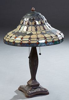 Tiffany Style Table Leaded Glass Lamp, late 19th c., the tapered circular shade with amber cabochon jewels, on a brown patinated tapered support, with