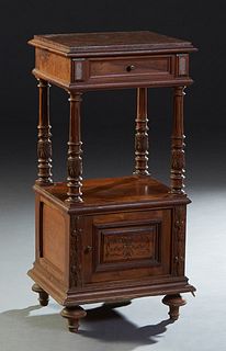 French Carved Walnut Marble Top Nightstand, early 20th c., the inset highly firgure rouge marble over a frieze drawer, on reeded and turned supports t