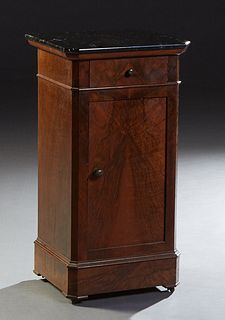 French Louis Philippe Carved Walnut Marble Top Nightstand, 19th c., the figured black canted corner marble over a frieze drawer and a long cupboard do