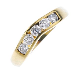 A diamond five-stone ring. The brilliant-cut diamond line, within a channel-setting, to the curved b