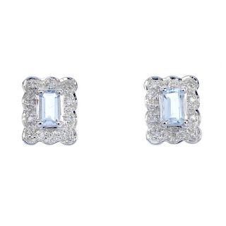 A pair of 9ct gold aquamarine and diamond ear studs. Each designed as a rectangular-shape aquamarine