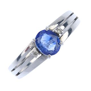 A sapphire and diamond three-stone ring. The oval-shape sapphire, with brilliant-cut diamond sides,
