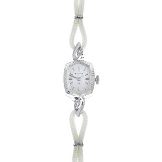 BULOVA - a lady's wrist watch. The silver colour dial with baton markers, to the textured bezal, wit